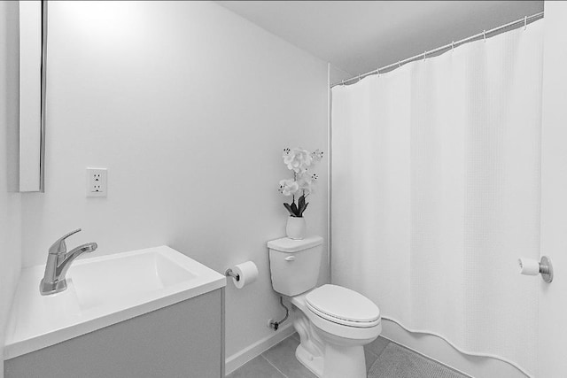 74 Storms Ave, Jersey City, NJ 07306 - bathroom with toilet, vanity, tile patterned flooring, a shower with shower curtain, and baseboards