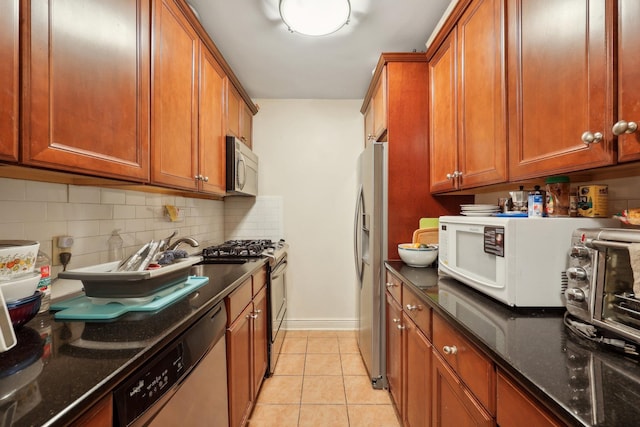 500 Central Ave Unit 1713, Union City, NJ 07087 - kitchen featuring stainless steel appliances, dark stone counters, and brown cabinets