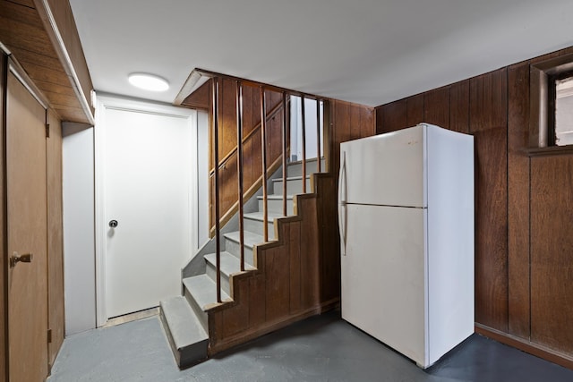 interior space with wooden walls and concrete floors