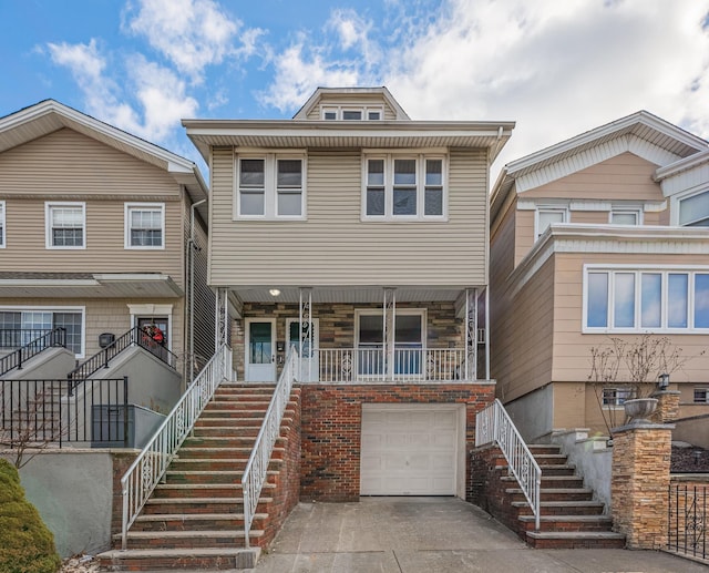 townhome / multi-family property featuring a garage and covered porch