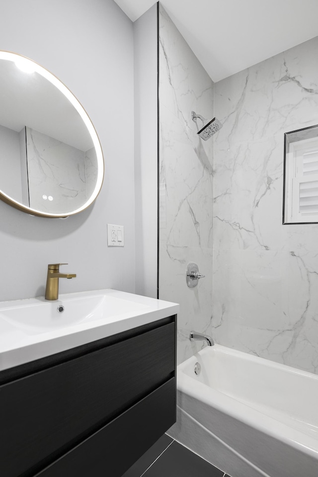 bathroom featuring tile patterned flooring, tub / shower combination, and vanity