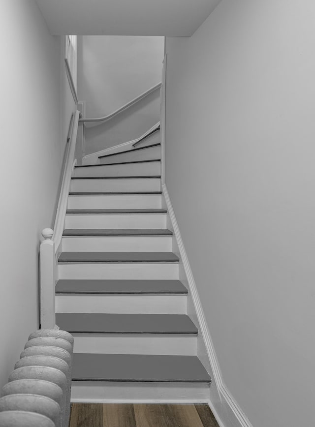 stairs featuring wood-type flooring