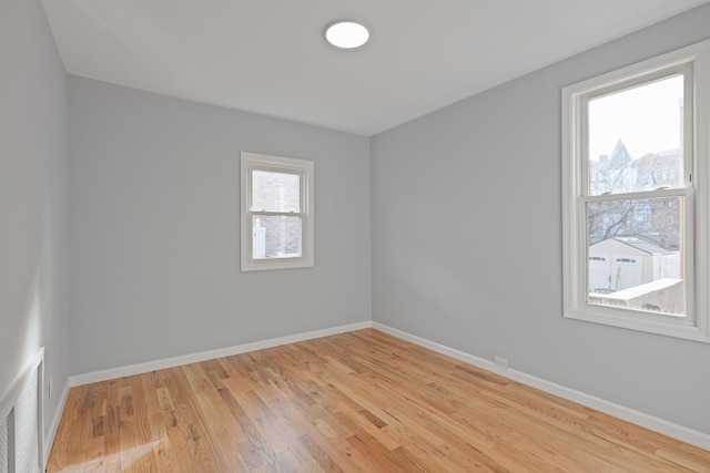 empty room with light hardwood / wood-style floors