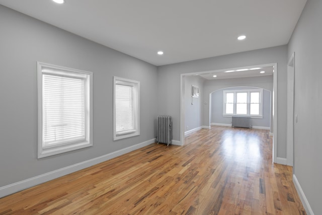 interior space with light hardwood / wood-style flooring and radiator heating unit