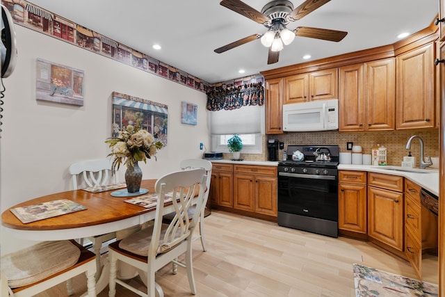 27 E 34th St, Bayonne, NJ 07002 - kitchen with white microwave, gas range, dishwashing machine, light countertops, and ceiling fan