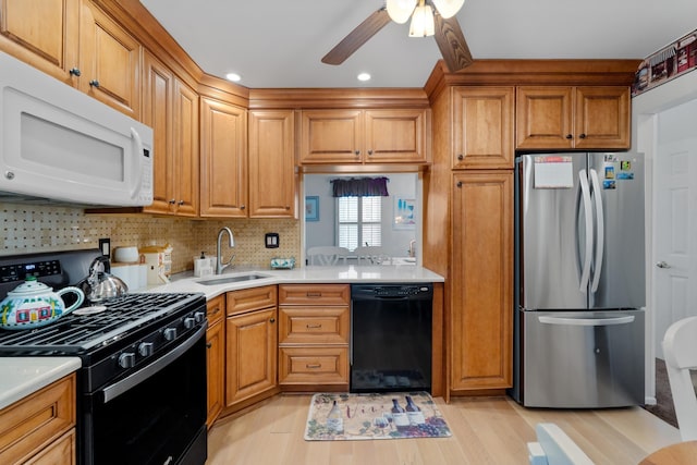 27 E 34th St, Bayonne, NJ 07002 - kitchen with black appliances, a ceiling fan, light countertops, light wood-style floors, and recessed lighting