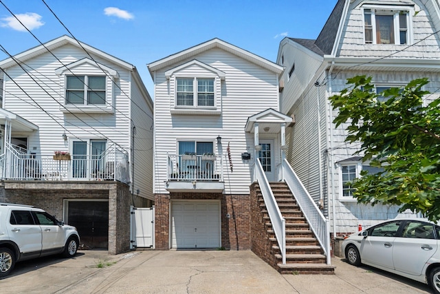 27 E 34th St, Bayonne, NJ 07002 - view of front facade featuring driveway, a garage, and brick siding