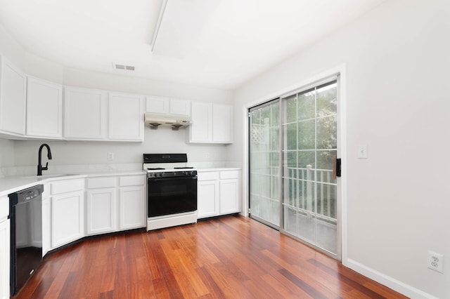 11 Crabapple Ct, Jersey City, NJ 07305 - kitchen with gas range gas stove, black dishwasher, under cabinet range hood, wood finished floors, and light countertops