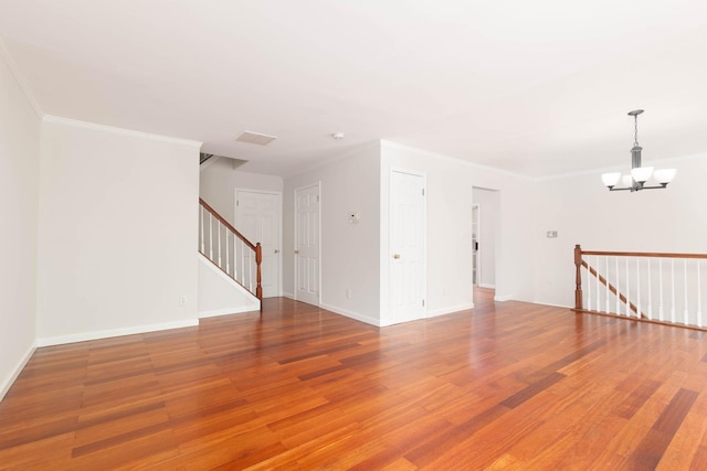 11 Crabapple Ct, Jersey City, NJ 07305 - unfurnished room featuring light wood-style floors, a chandelier, ornamental molding, and stairs