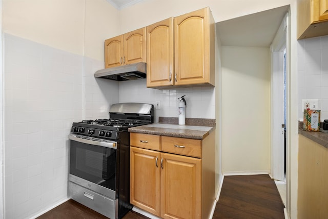 kitchen with stainless steel range with gas cooktop, dark wood-style flooring, dark countertops, backsplash, and under cabinet range hood