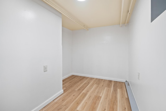 unfurnished room with light wood finished floors and baseboards