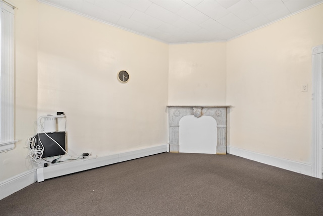 unfurnished living room featuring carpet flooring, crown molding, and baseboards