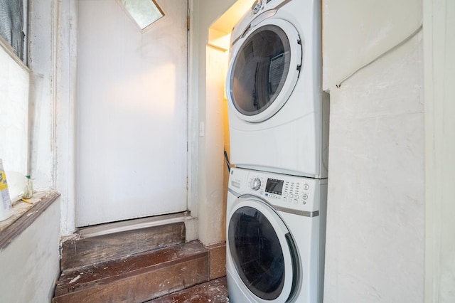 washroom with laundry area and stacked washer / dryer