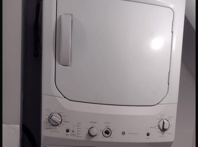 laundry area featuring stacked washer / dryer