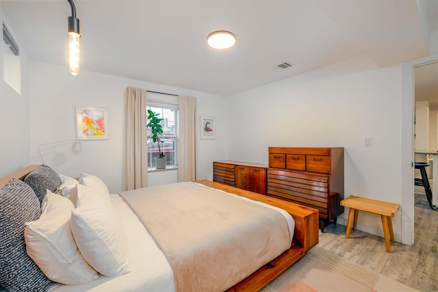 bedroom with light hardwood / wood-style floors