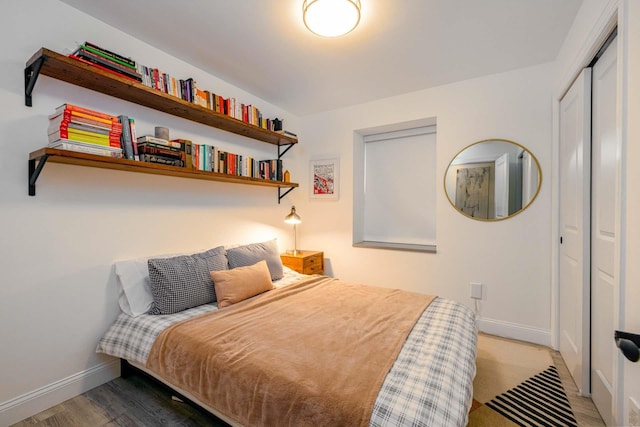 bedroom with hardwood / wood-style flooring and a closet