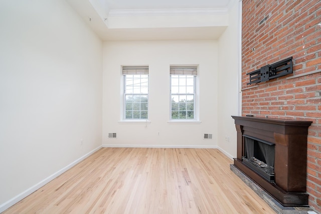 unfurnished living room featuring light hardwood / wood-style floors and ornamental molding