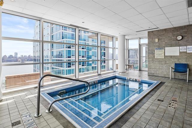 1 Shore Ln Unit 1805, Jersey City, NJ 07310 - view of pool featuring an in-ground hot tub and a view of city