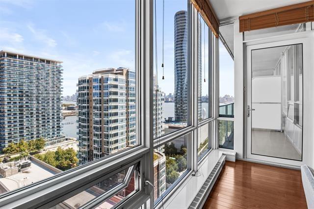 1 Shore Ln Unit 1805, Jersey City, NJ 07310 - unfurnished sunroom with healthy amount of natural light and a view of city