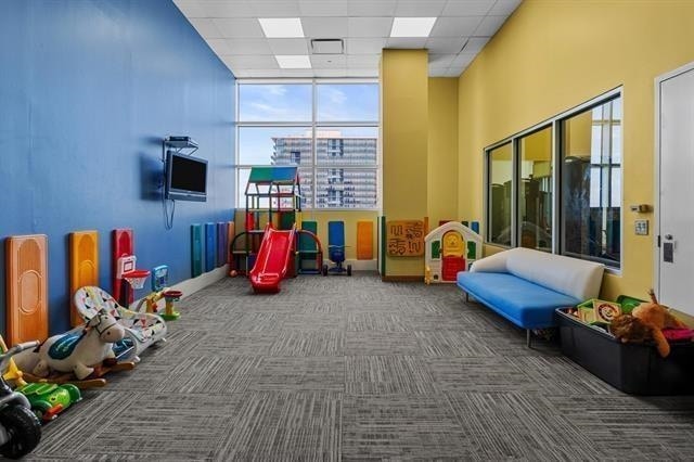 1 Shore Ln Unit 1805, Jersey City, NJ 07310 - rec room featuring carpet floors and a drop ceiling