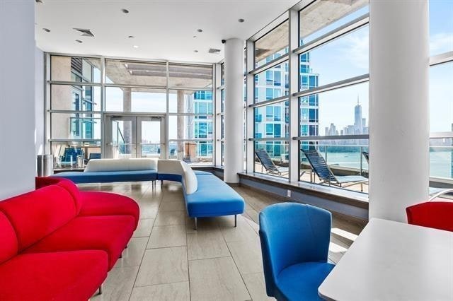 1 Shore Ln Unit 1805, Jersey City, NJ 07310 - lobby featuring a wall of windows and a city view