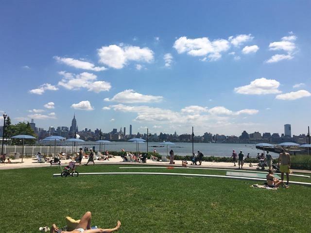 1 Shore Ln Unit 1805, Jersey City, NJ 07310 - view of property's community featuring a yard, a game area, a water view, and a view of skyline