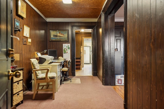 home office featuring carpet floors, wooden walls, and crown molding