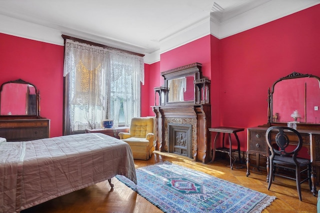 bedroom with ornamental molding and a fireplace