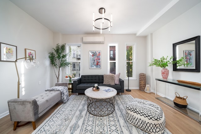 living room featuring light wood-type flooring and a wall unit AC