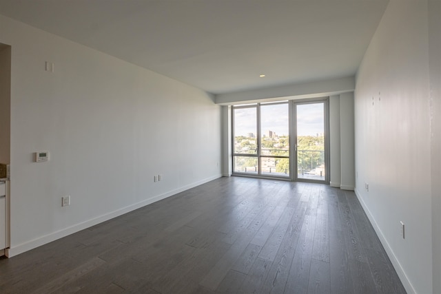 unfurnished room featuring dark hardwood / wood-style flooring