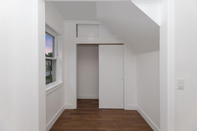 hallway with dark wood finished floors and baseboards