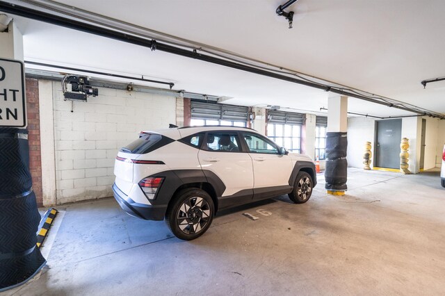 parking garage featuring concrete block wall