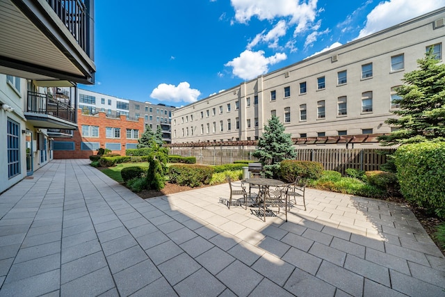 view of patio featuring outdoor dining space and fence