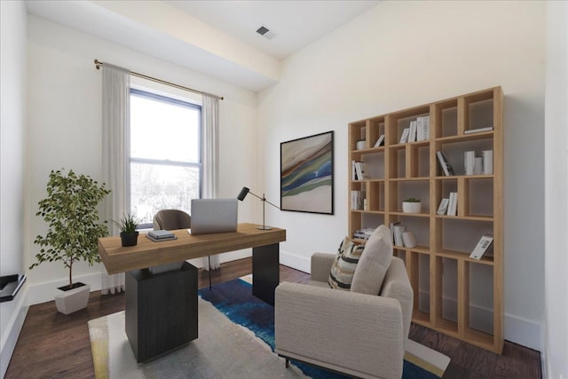 home office with dark hardwood / wood-style floors