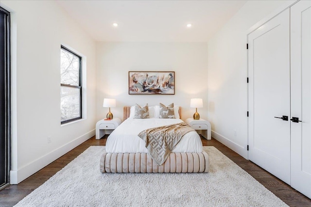 bedroom with dark hardwood / wood-style floors