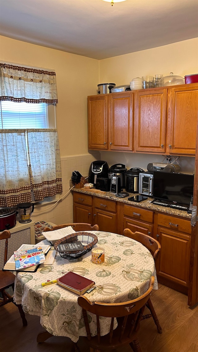 kitchen with dark wood-type flooring and stone countertops