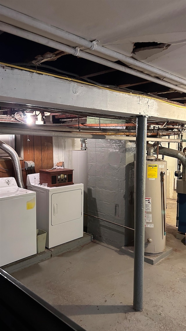 basement featuring gas water heater and separate washer and dryer