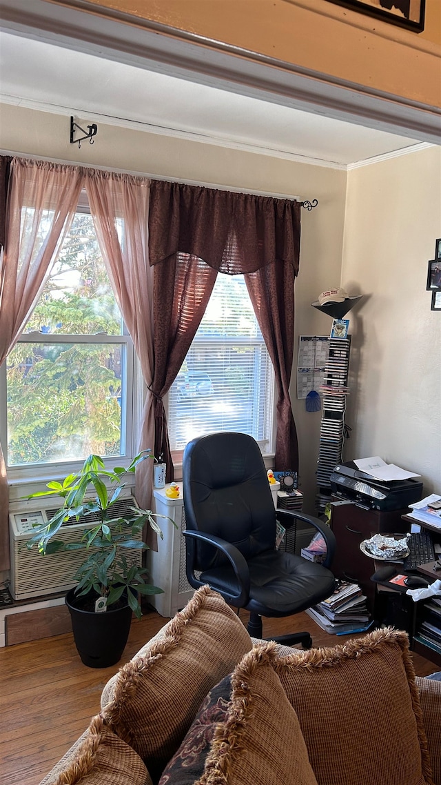 sitting room with wood-type flooring and crown molding