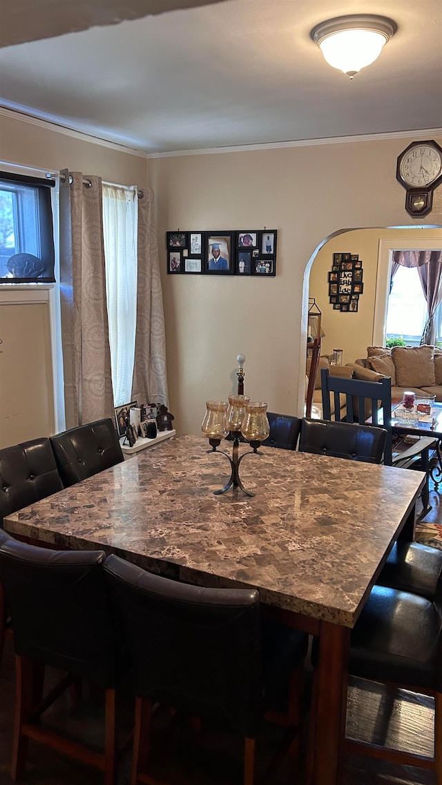 dining space with crown molding