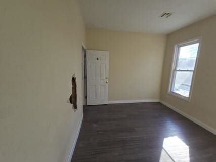 unfurnished room with dark hardwood / wood-style floors