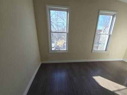 empty room with dark hardwood / wood-style floors