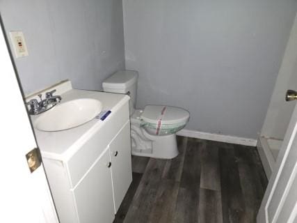 bathroom featuring hardwood / wood-style floors, vanity, and toilet