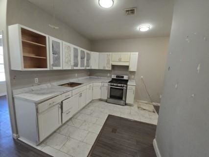 529 Communipaw Ave, Jersey City, NJ 07304 - kitchen featuring stainless steel range, light countertops, white cabinets, and glass insert cabinets