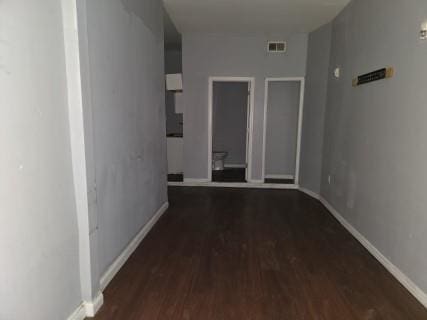 hall featuring dark wood-type flooring