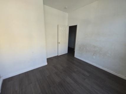 unfurnished room with dark hardwood / wood-style floors