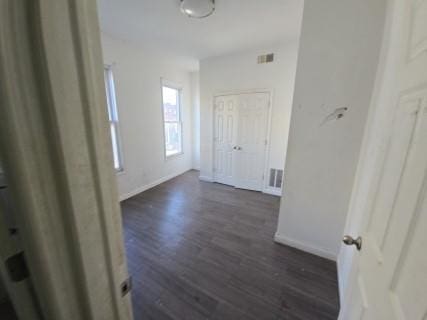 hallway featuring dark hardwood / wood-style flooring