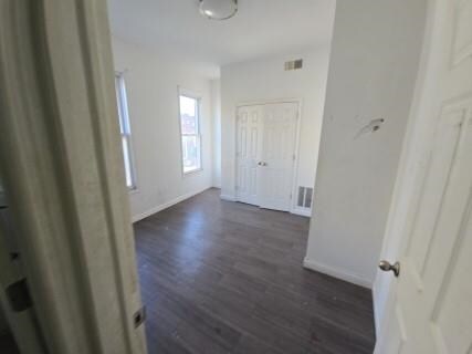 529 Communipaw Ave, Jersey City, NJ 07304 - hallway with dark wood finished floors and baseboards
