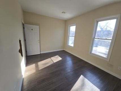 unfurnished room featuring dark hardwood / wood-style flooring