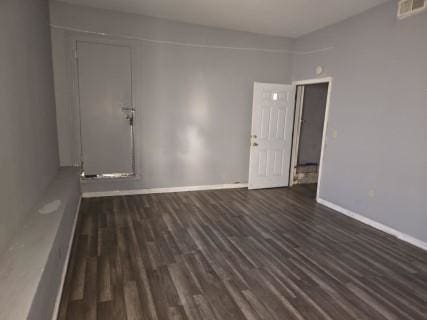 spare room with dark hardwood / wood-style flooring