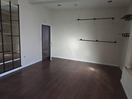 empty room with dark hardwood / wood-style floors